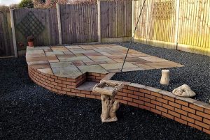 raised patio with brick wall